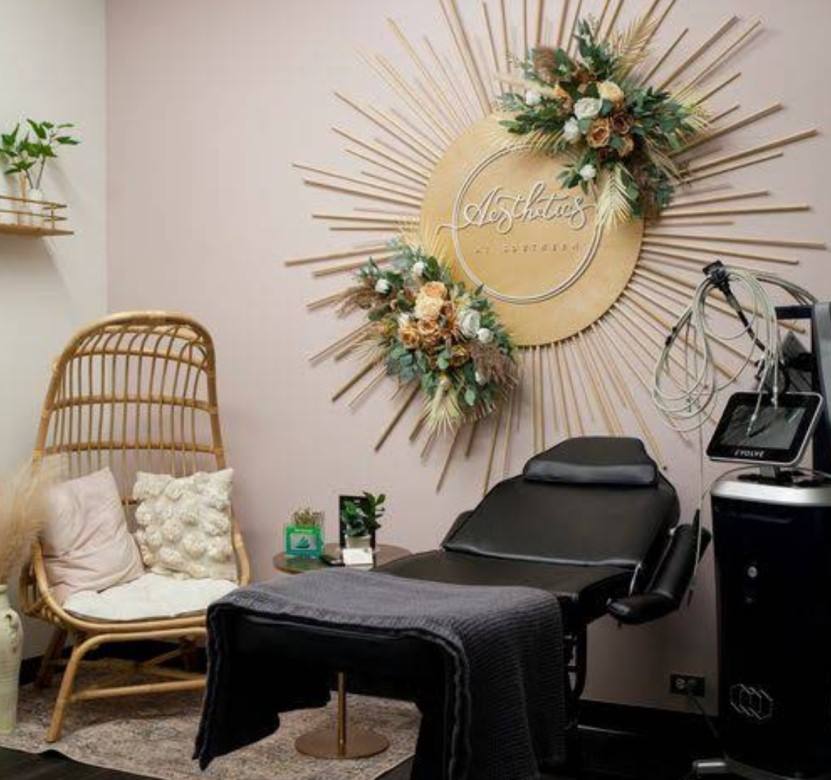 Private esthetics treatment room with sunburst wall art
